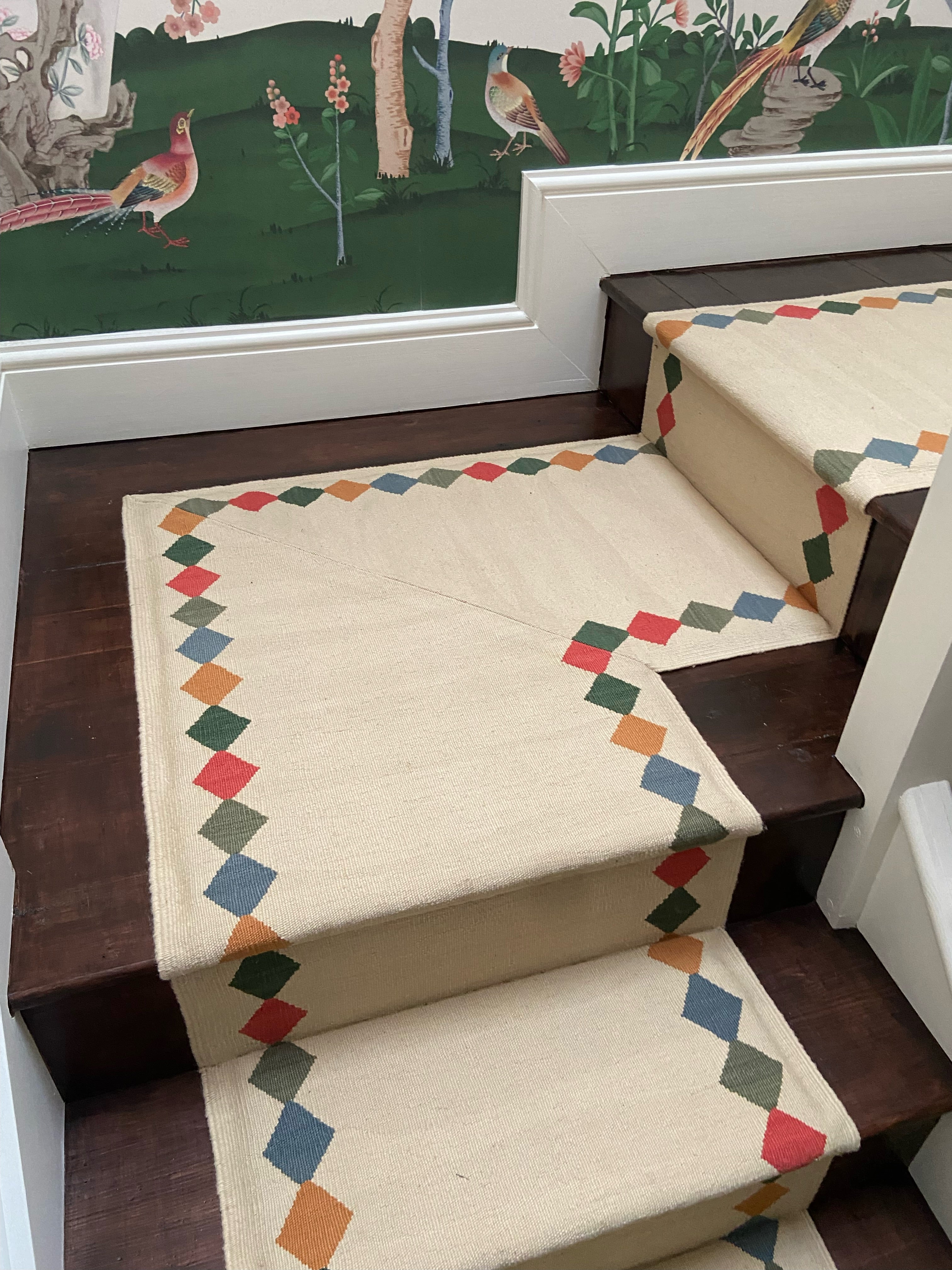 Staircase with a decorative Wool Sophie Cooney Runners stair runner featuring the geometric Azra pattern on a wooden floor.