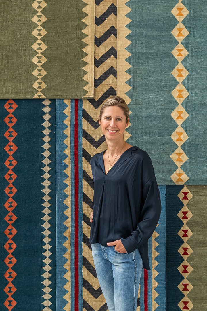 Sophie Cooney in front of a selection of her beautiful handwoven runners