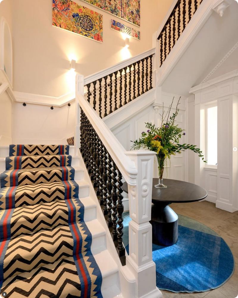 Extra wide Tribal design in Sky blue on a white staircase, situ image for Sophie Cooney