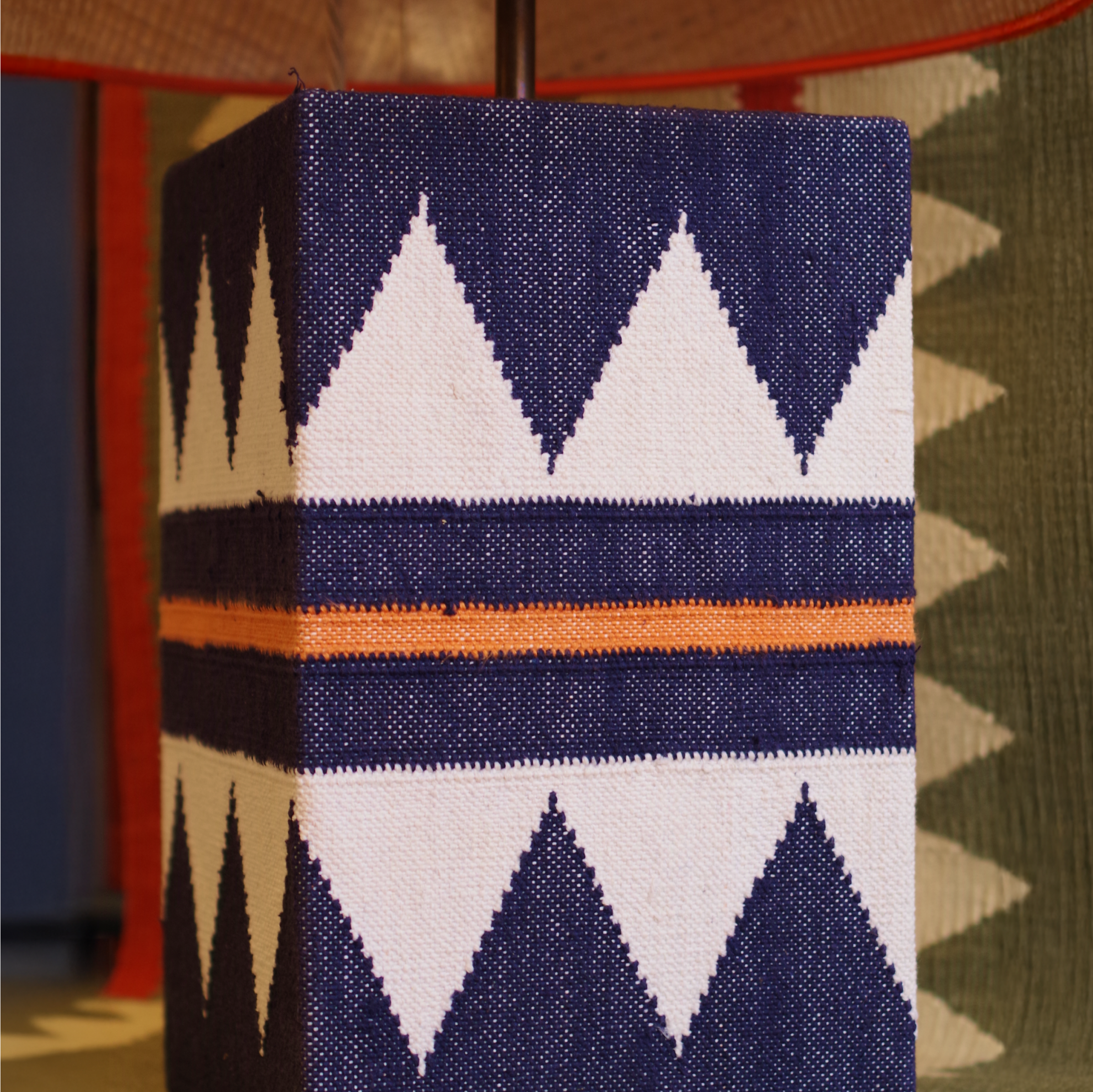 Zuri navy raw cotton lamp close up by Sophie Cooney Runners against a green zuri background
